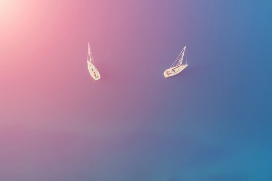 Top view of two white yachts at sea on a sunny day