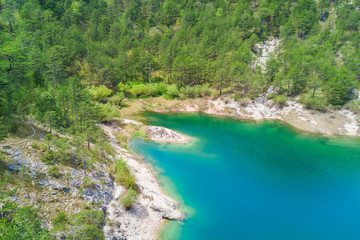 Top view of a beautiful mountain lake surrounded by green forest