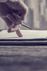 Businessman hand pointing with his finger where to sign a contract or document