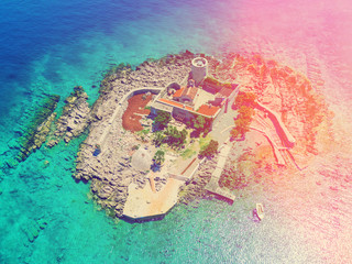 Top view of the island with a fortress in the sunlight