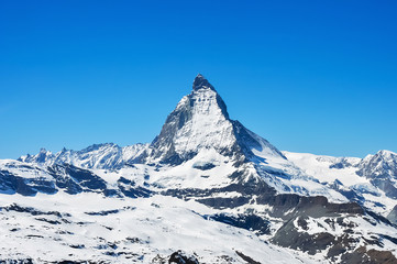 snowy Matterhorn peak with blue sky background, Switzerland.
