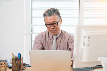senior asian male at work