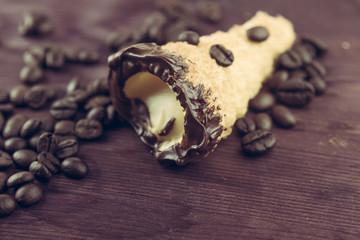 delicious sicilian cannolo cannellino sweet with pastry hazelnut near coffee beans