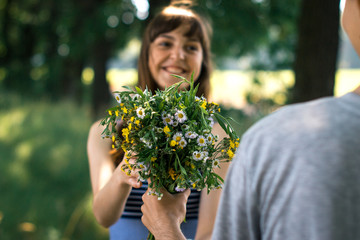 Surprise for girl gift flowers young surprised girl in the park.