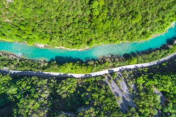 Top view of the river in the mountains surrounded by a green forest