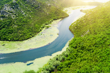 Top view of a river covered with green algae in the mountains