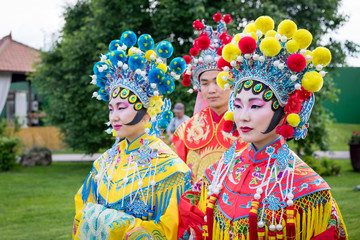 Fototapeta premium group of three asian people, man and women outdoor in traditional chinese costumes
