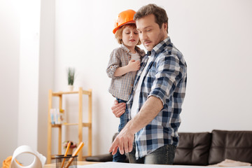 Delighted boy being glad to be hand of his father