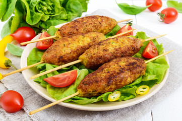 Lula-kebab is a meat dish, traditional for the Caucasus, in Central Asia and Turkey. Minced meat strung on a skewer and fried. Serve on a plate with lettuce leaves and fresh tomatoes.