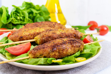 Lula-kebab is a meat dish, traditional for the Caucasus, in Central Asia and Turkey. Minced meat strung on a skewer and fried. Serve on a plate with lettuce leaves and fresh tomatoes.