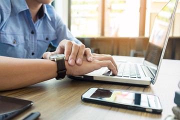 Fototapeta premium Business man pointing his watch with his finger at office