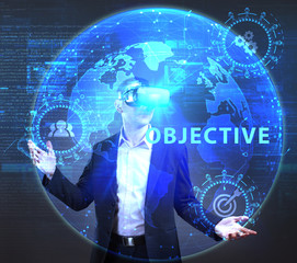 The concept of business, technology, the Internet and the network. A young entrepreneur working on a virtual screen of the future and sees the inscription: Objective