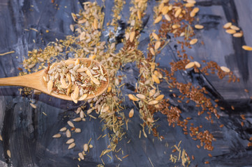 seeds and spices on table and wooden spoon
