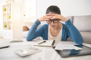 stressed worried young woman doing banking
