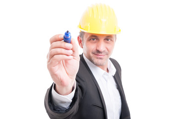 Selective focus of architect wearing hardhat writing with marker