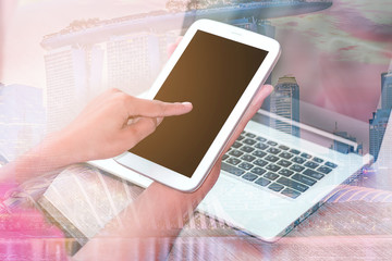 Close Up businessmen working at a coffee shop with a document with a smartphone and a laptop computer.