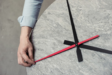 cropped shot of man holding second hand of clock