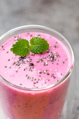Smoothie, pink juice on the grey  background.