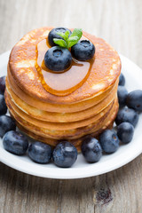 Stack of pancakes with blueberry and fresh berry.