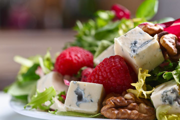 Green salad with blue cheese , raspberry and nuts