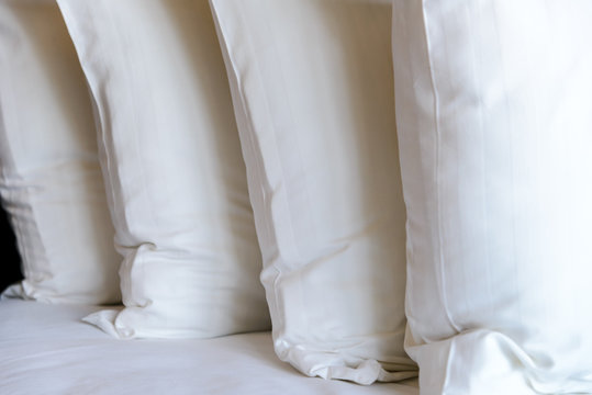 stacking of white pillows on bed - Close up