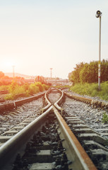 Two railways tracks merge close up.Vintage tone. Vertical photography.