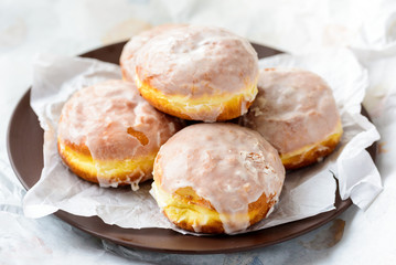 Many donuts on a plate and paper