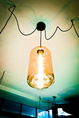 Light bulb hang from the ceiling, long shape and shining.