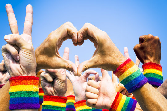 Crowd of hands making supportive signals at gay pride parade