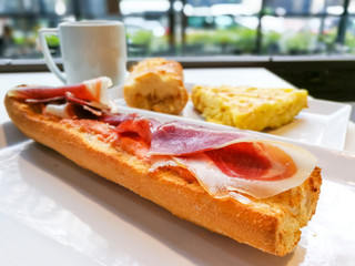Breakfast with coffee and fresh bread on table
