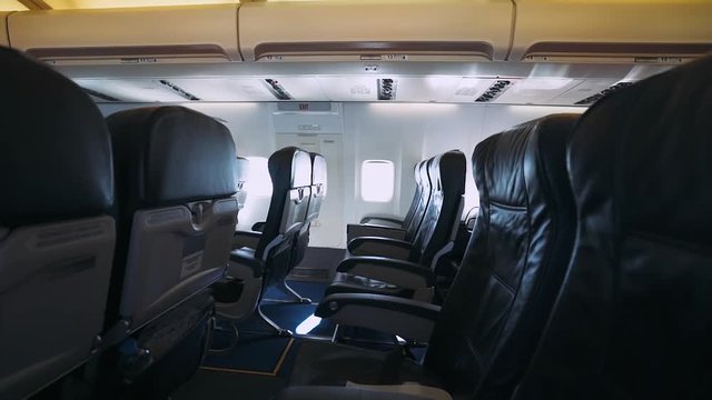 Airplane flies into the air, view on the interior of the plane, the passenger seats and the porthole. 
