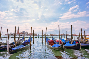 Fototapeta na wymiar Grand canal at sunset in Venice, Piazza San Marco. On the background the island San Giorgio. Scenic cityscape with gondolas