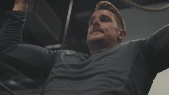 Male crossfit athlete doing pullups