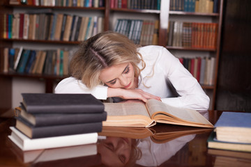the girl was preparing for the exam reading book sleeping