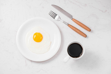 Top view of traditional healthy easy quick breakfast meal made of fried eggs served on a plate.