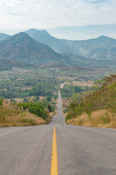 Lanscape local road of North Thailand, Portrait of countryside road with mountain and sky