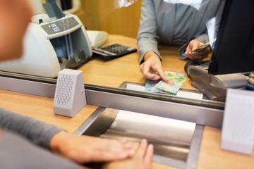 clerk counting cash money at bank office
