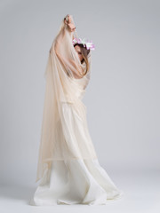Fototapeta na wymiar young bride in a wedding dress with a veil