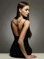 Fototapeta premium beautiful young woman in sexy dress and jewelry