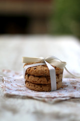 Chocolate chip cookies on a floral napkin, tied with a bow. Selective focus. 
