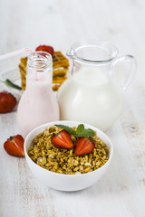 Granola with strawberry, milk and smoothies