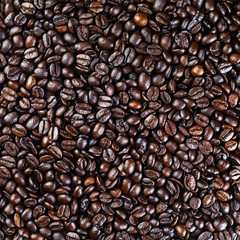Brown coffee beans background. Coffee beans texture. Top view