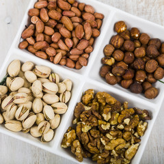 Bowl with nuts on a  wooden table