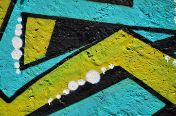 Background image of the wall decorated with colorful abstract graffiti. Street art concept