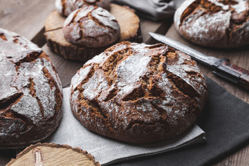 Delicious fresh bread on wooden background