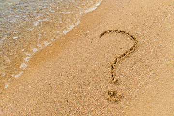 Fototapeta na wymiar a symbol of question in the sand