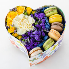 box in the shape of a heart with flowers and macaroons