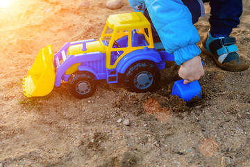 a boy playing with a toy tractor