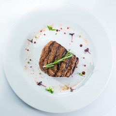 grilled steak on a white plate