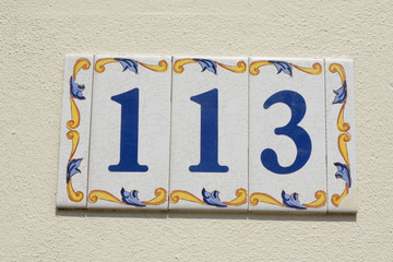 Fototapeta premium House number 113 sign in ceramic tiles